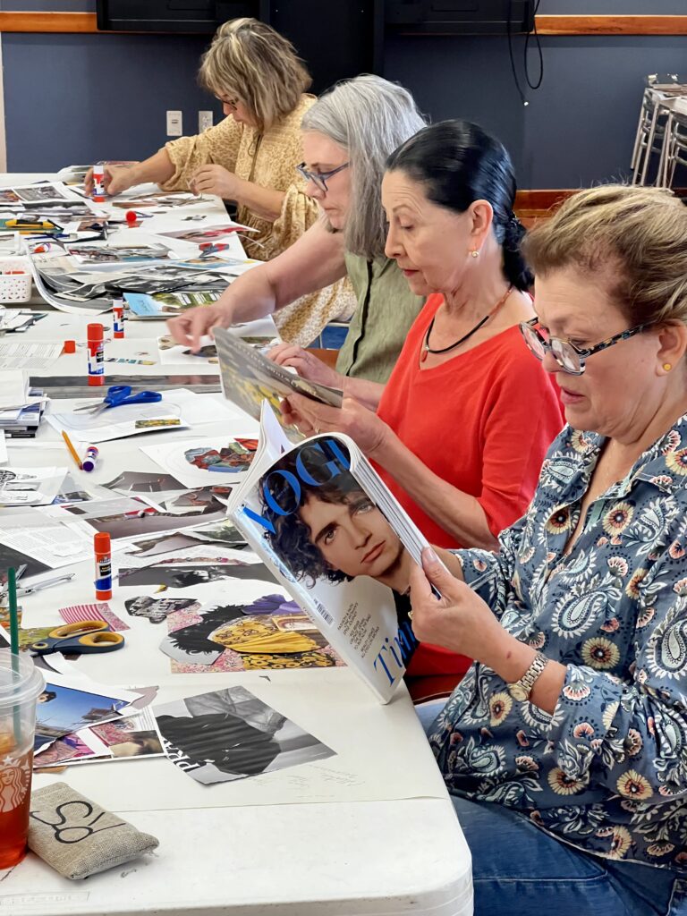 Participants at a collage workshop, seated, with works in progress.